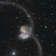 Illustration for article titled The colliding Antennae galaxies create 500,000 light-years of chaos